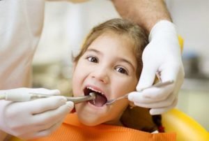 child undergoing a dental exam
